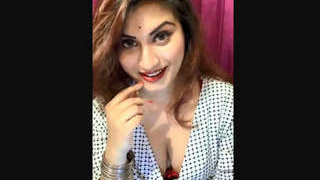 Gunjan Aras in a live show on her app, showing off her deep cleavage and playing a game of clothes changing