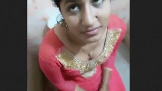 A woman gives a blowjob in the bathroom to a man