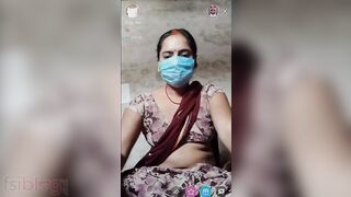 Indian wife hides her face behind a mask while showing off her body on camera