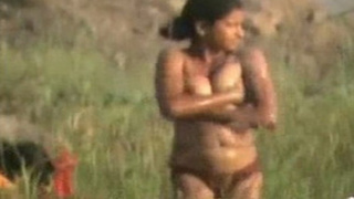 A young Indian girl enjoys a nude bath in the countryside