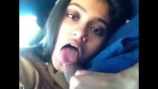 Indian girl gives her boyfriend a blowjob in a car