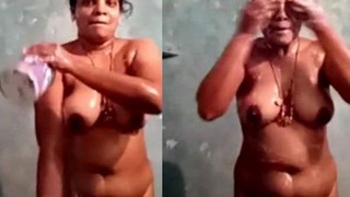 Mature desi aunty strips naked in the bathtub