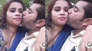 Husband films and enjoys romantic kisses with wife in park
