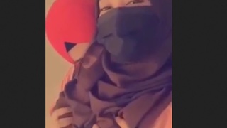 Hijab-clad lesbians in a passionate encounter