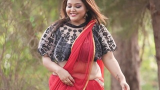 Nandini in a red saree shows off her navel for her lover